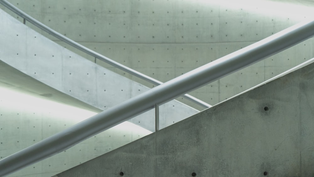 gray concrete staircase with stainless steel railings