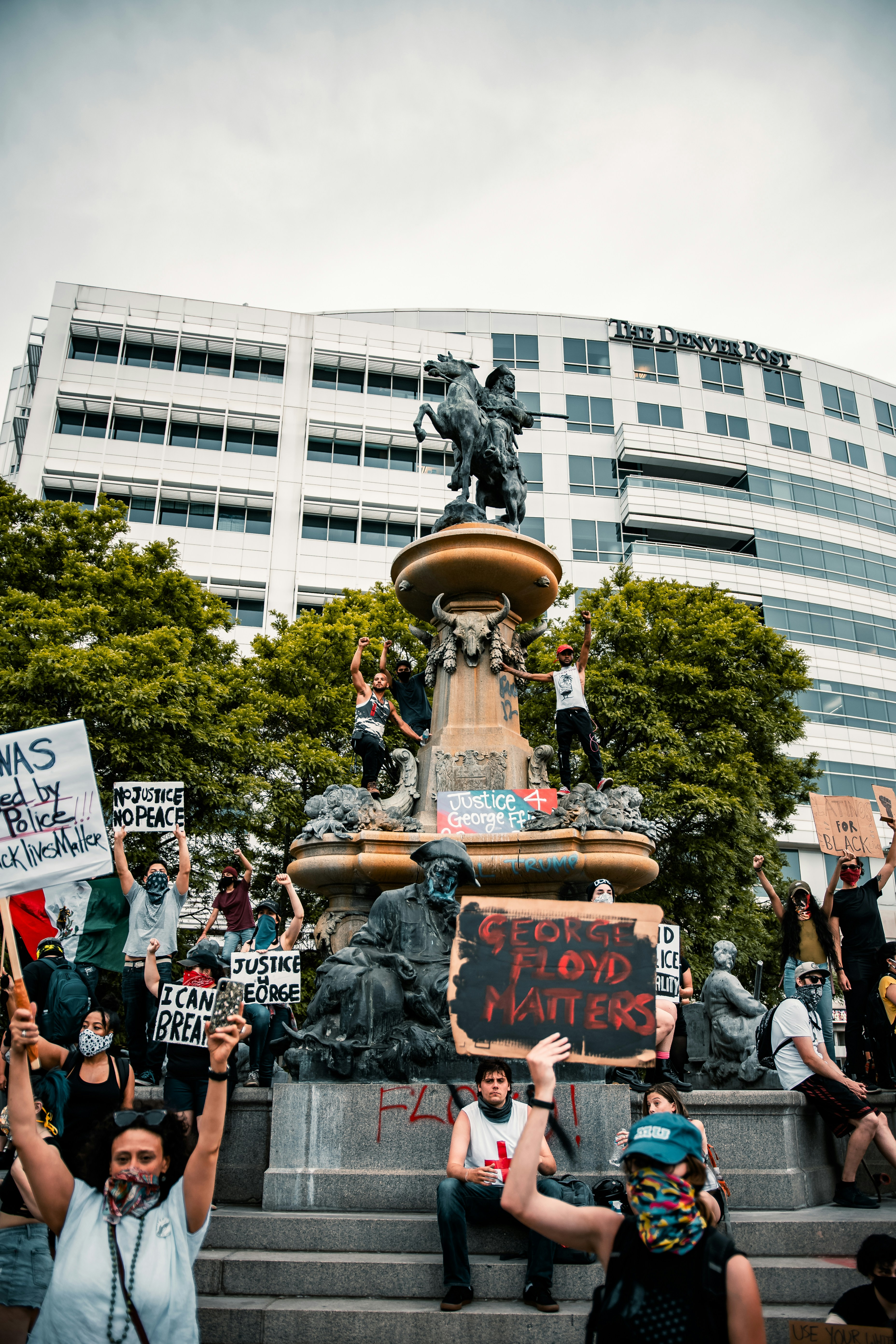 people walking on street near white concrete building during daytime