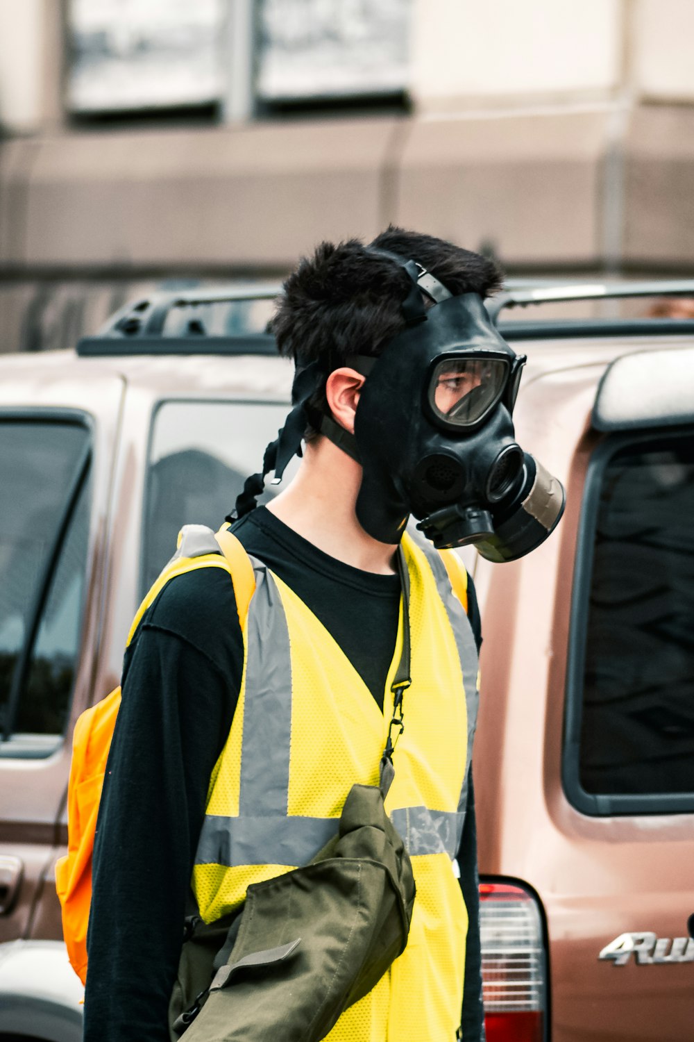 woman in yellow and black gas mask and yellow vest
