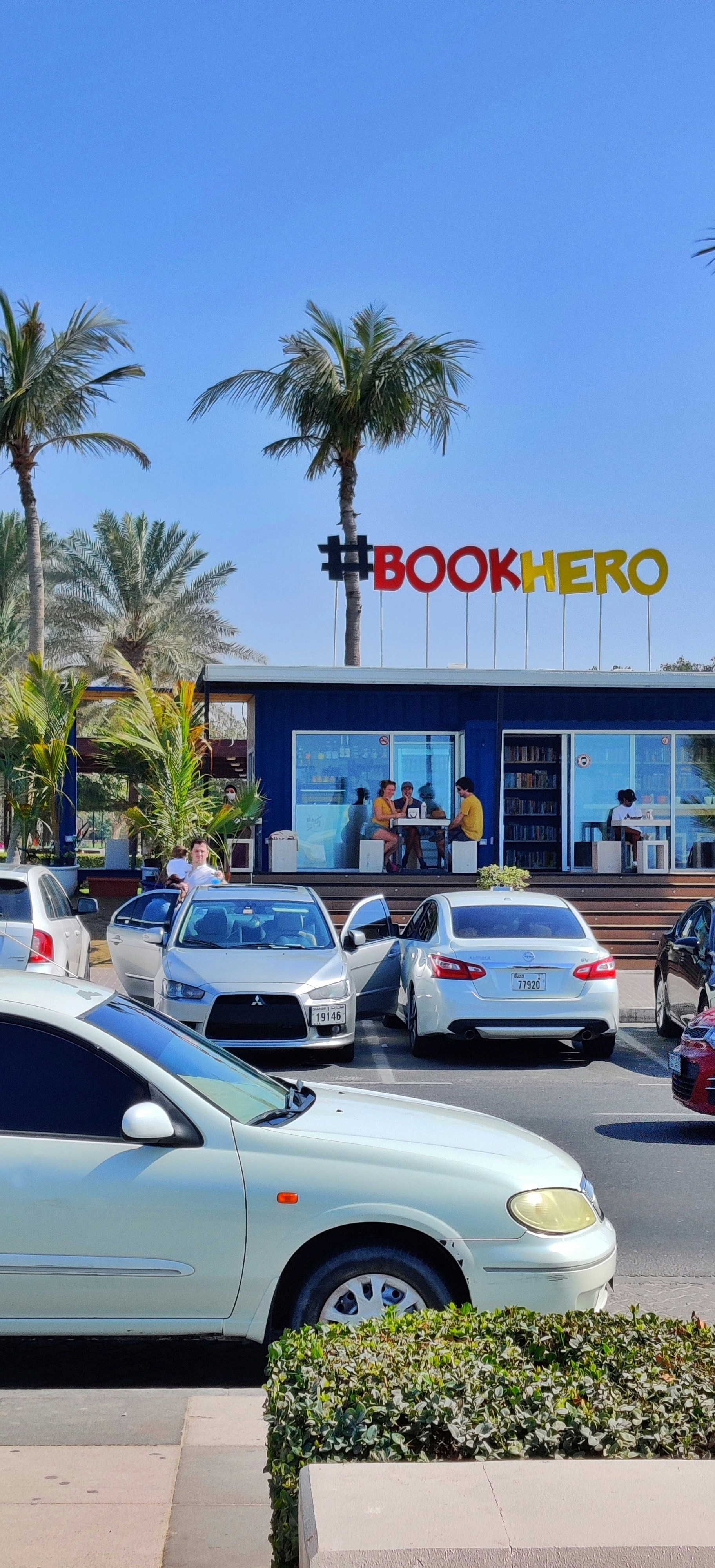 cars parked in front of UNKs store during daytime