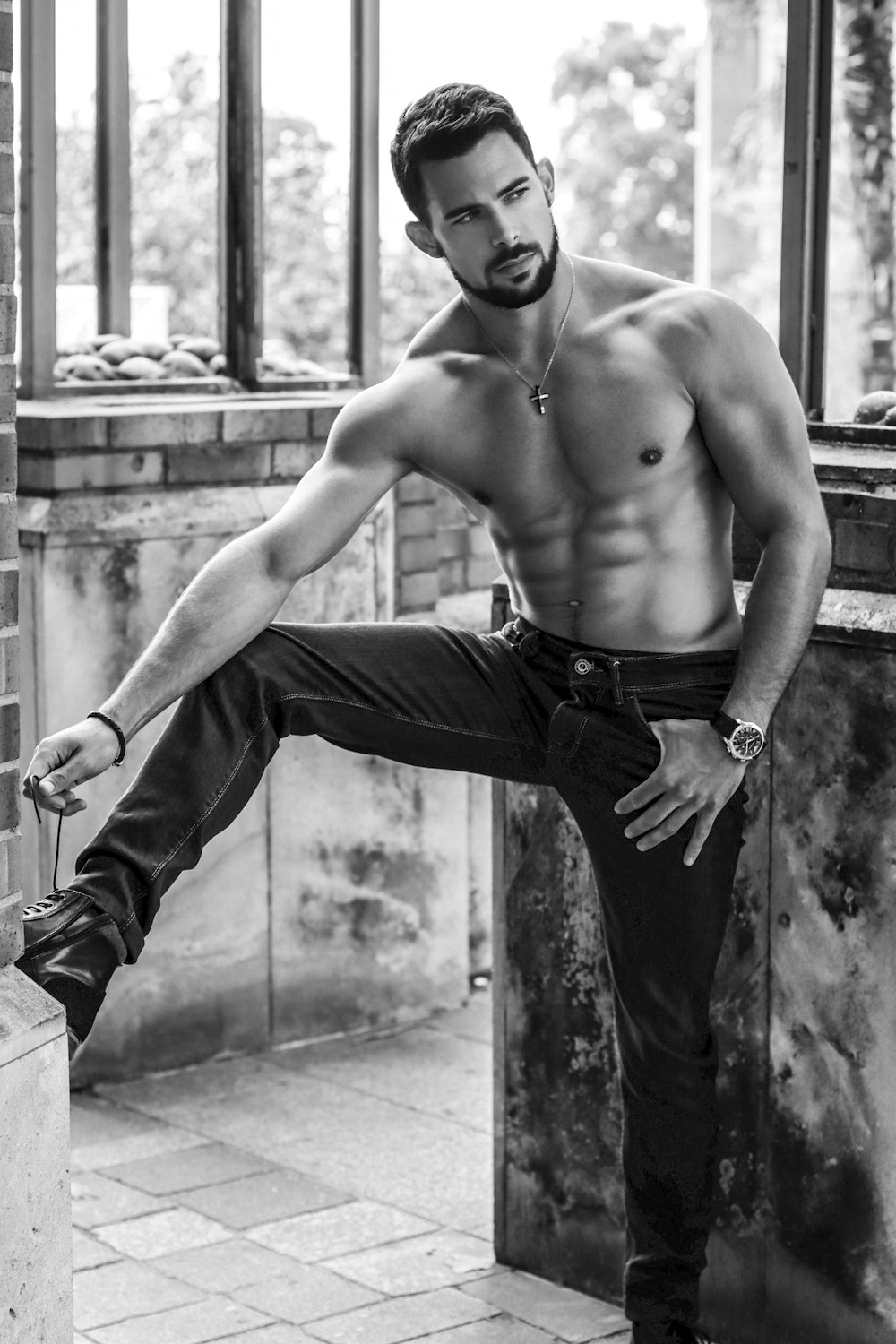topless man in black pants and black leather boots