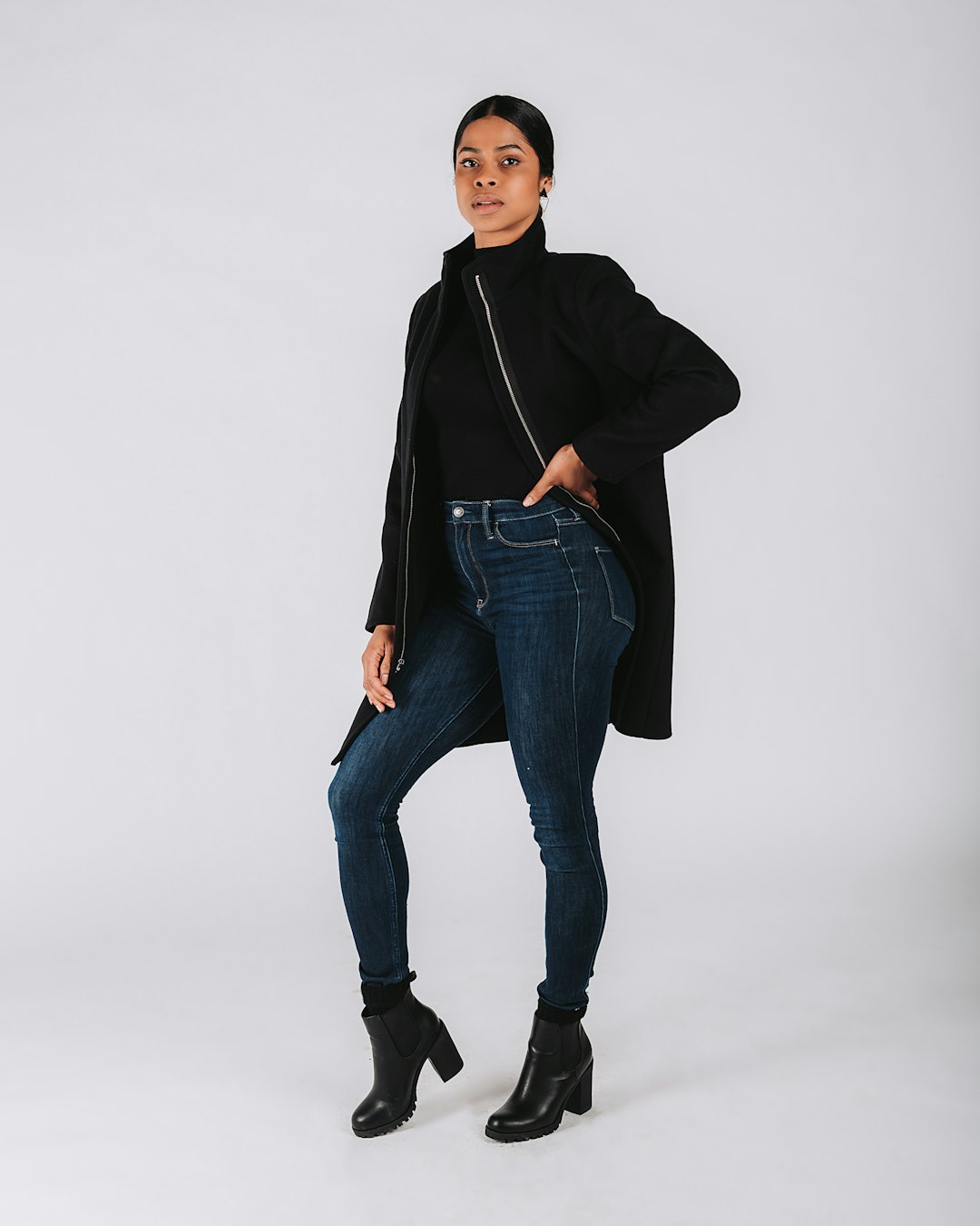 woman in black jacket and blue denim jeans