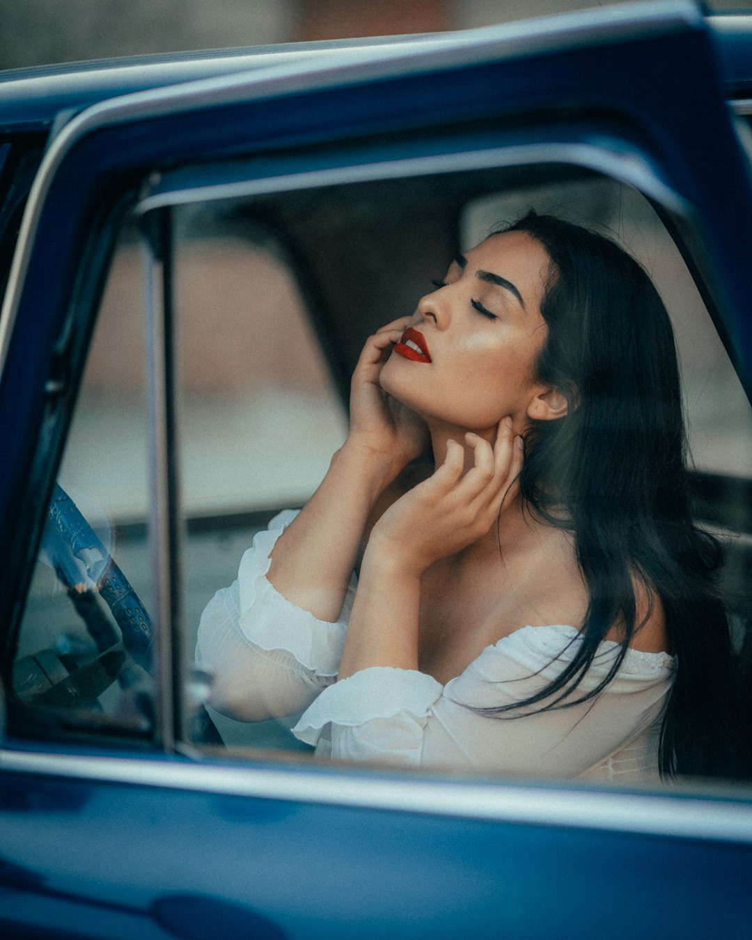 woman in white dress sitting on car