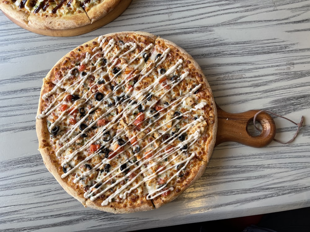 brown round pizza on brown wooden table