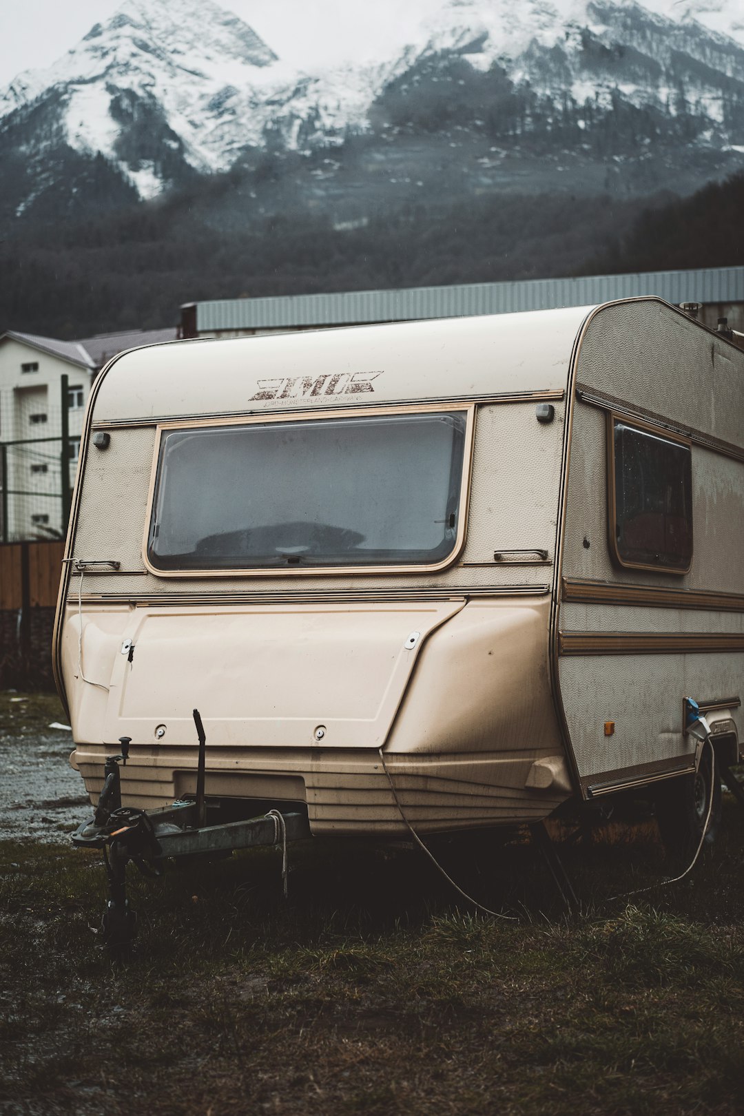 white and brown rv on water