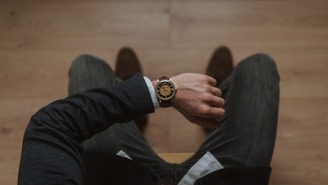 person wearing gold and white analog watch