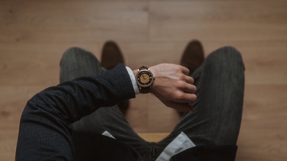 person wearing gold and white analog watch