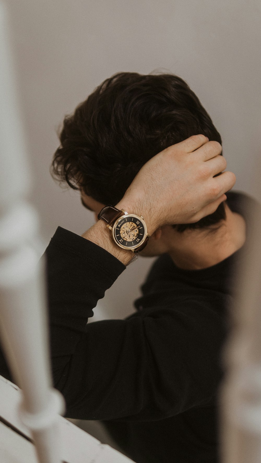 man in black long sleeve shirt wearing black round analog watch