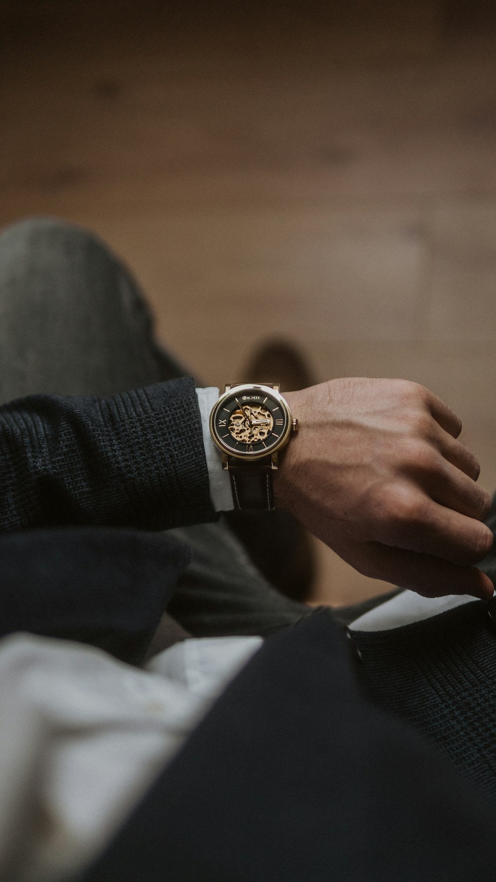 person wearing gold and silver round analog watch