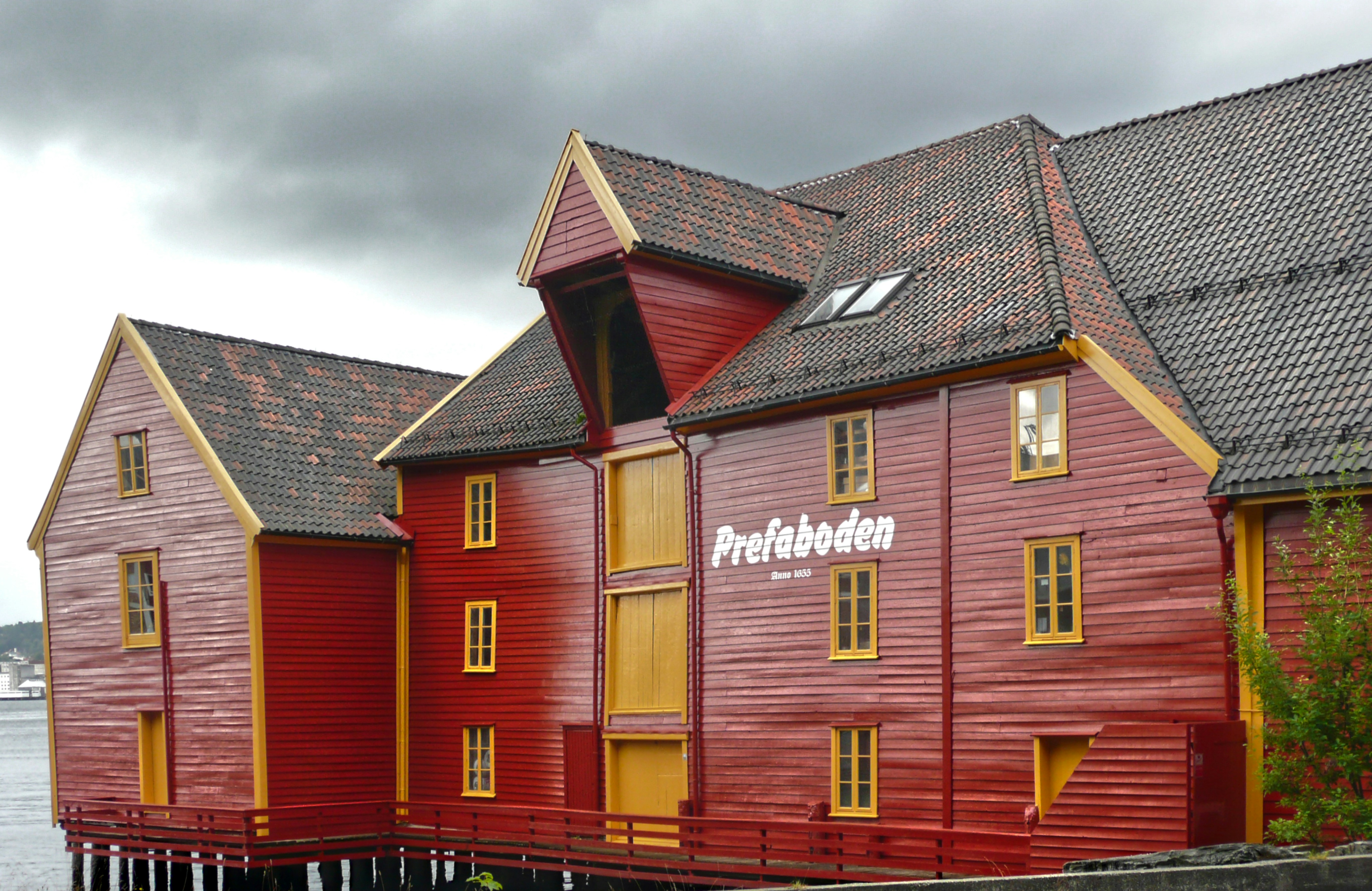 red wooden house under white clouds during daytime