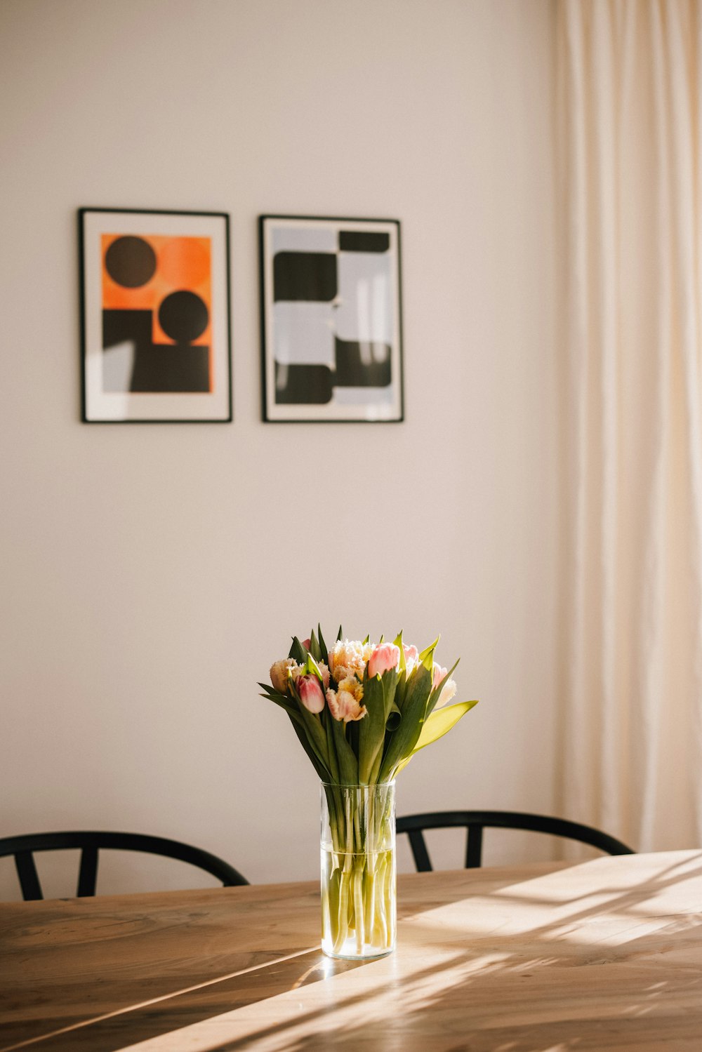 yellow and white flowers in clear glass vase on table