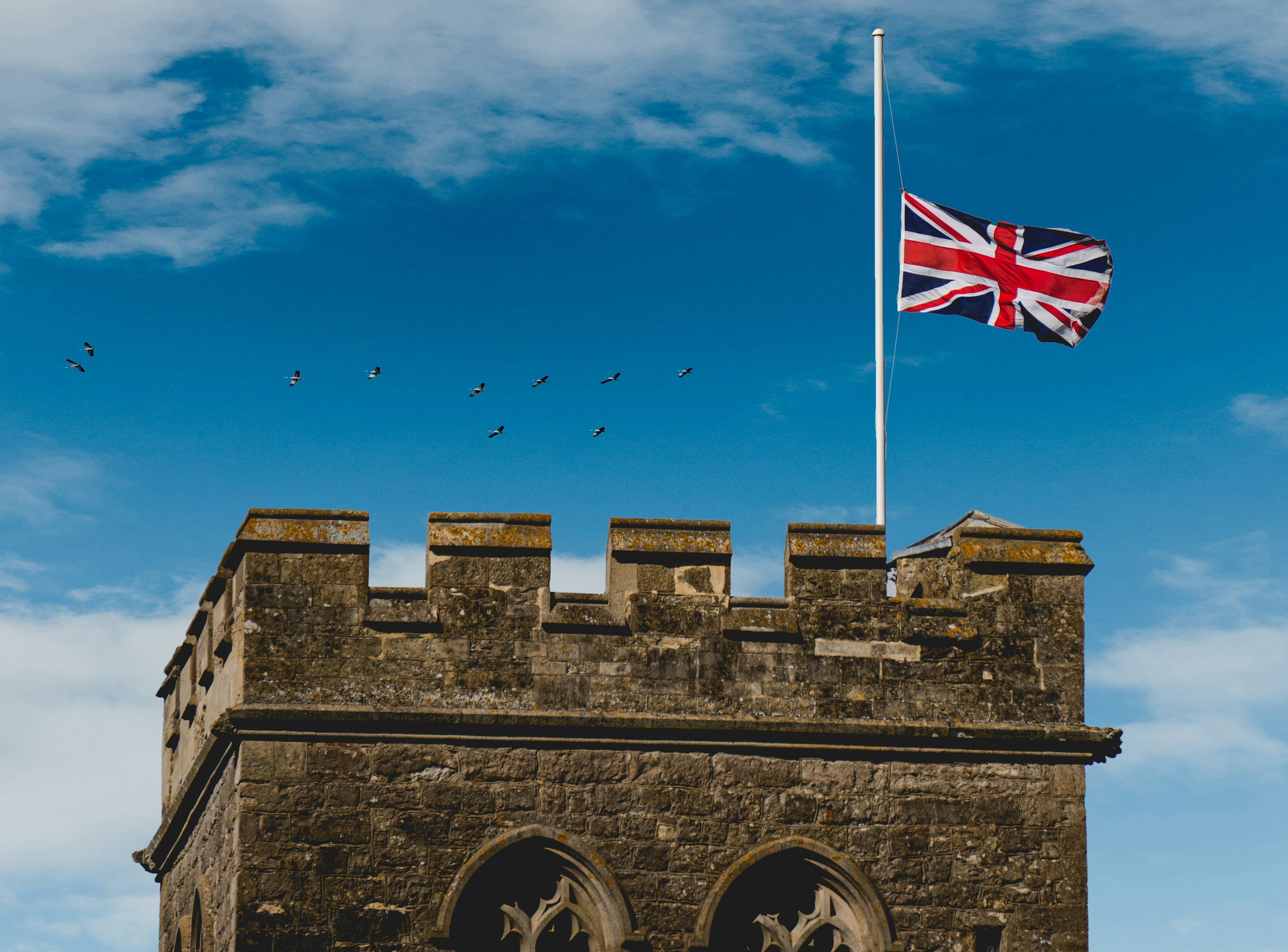Castle top with British flag flown at half mast