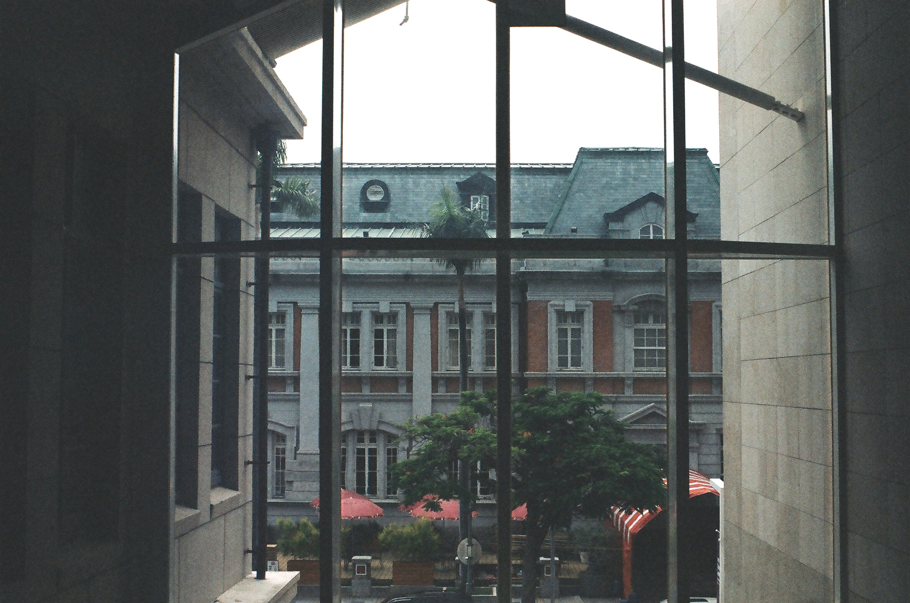 Green car parked near brown building
