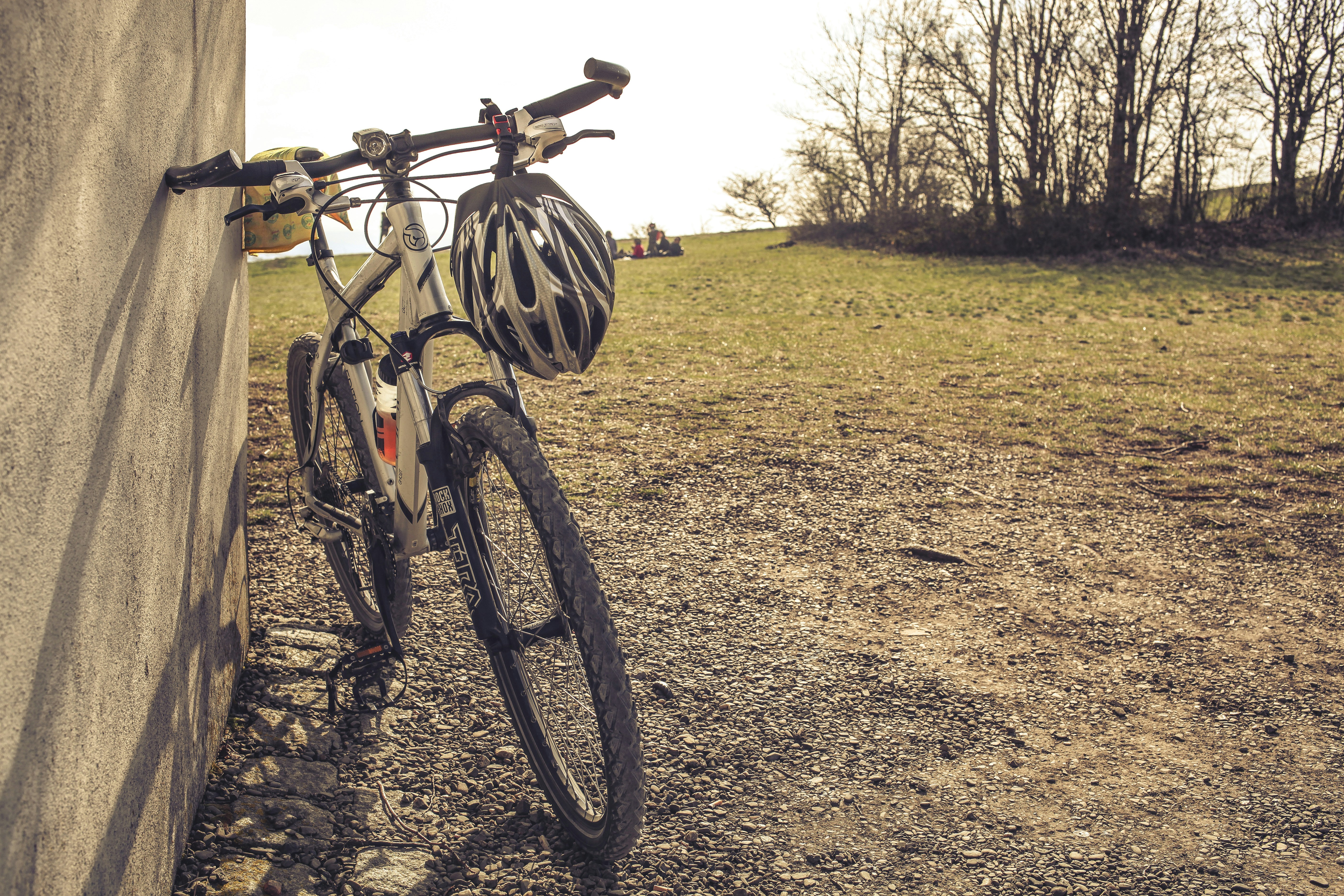 black and red bicycle on brown dirt road during daytime