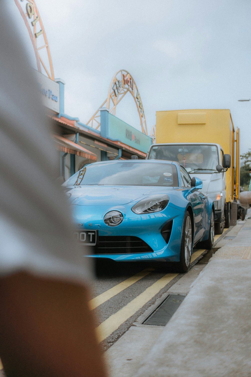 a blue sports car driving down a street