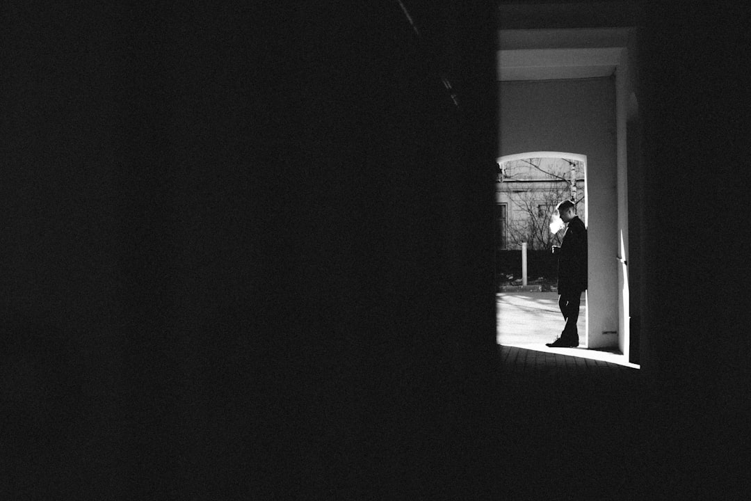 man in black jacket standing near door