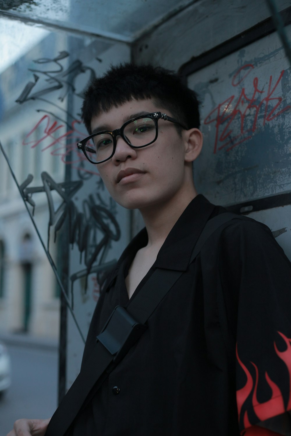 man in black framed eyeglasses and black jacket