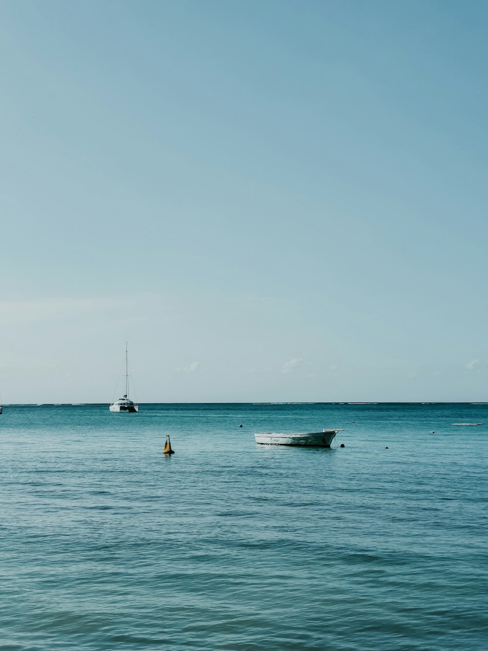 people riding on white and black boat on sea during daytime