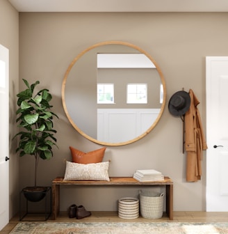 brown wooden framed mirror on white wall