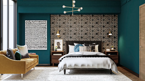 A modern bedroom featuring navy blue walls contrasted with copper light fixtures and artistic decor.