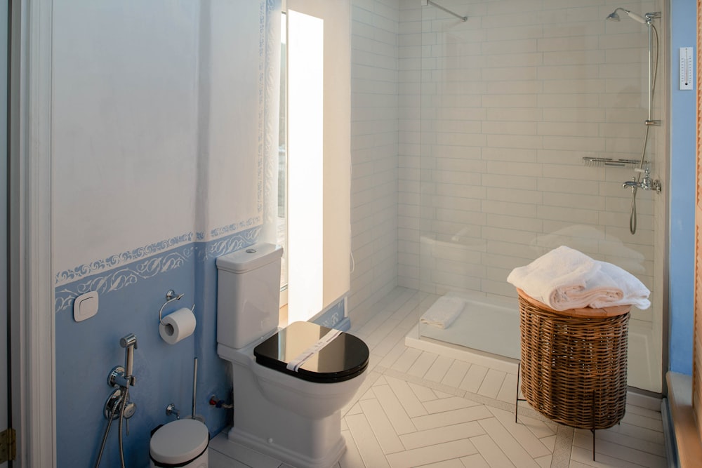 white ceramic sink beside white ceramic bathtub