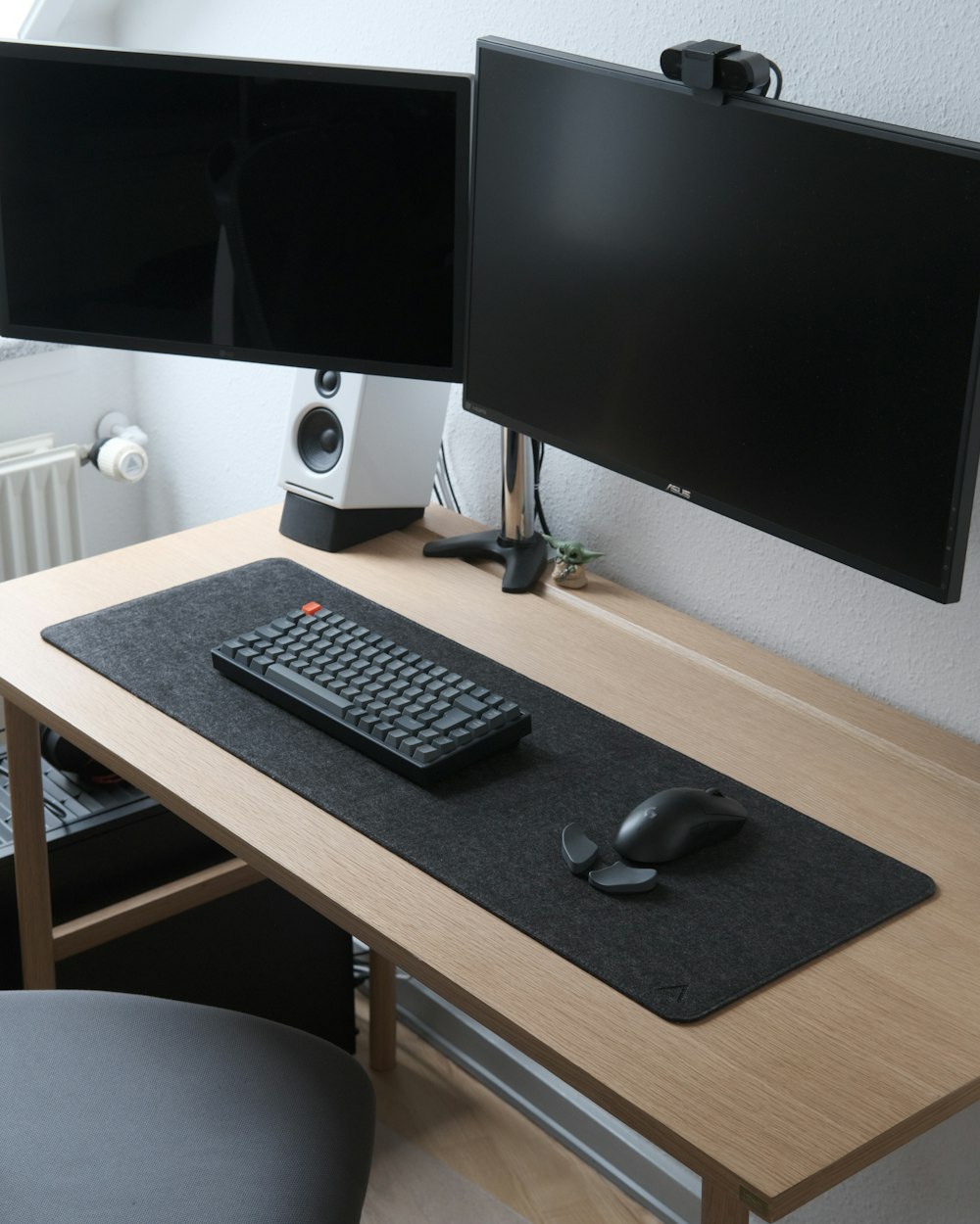 black computer keyboard and silver imac on brown wooden desk
