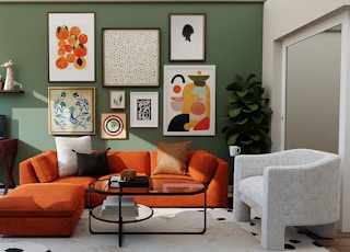 orange and black sofa with throw pillows