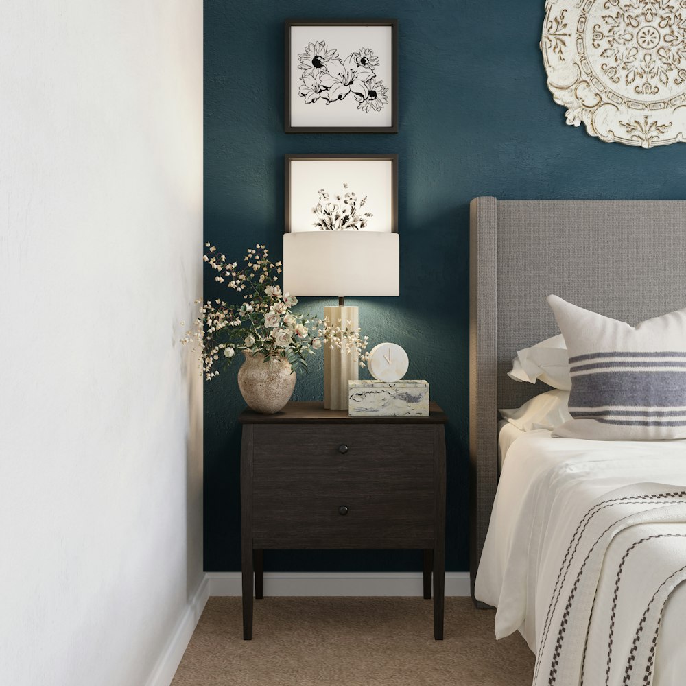 brown wooden nightstand beside bed