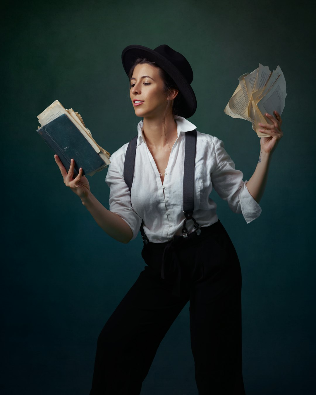 woman in white dress shirt and black pants holding white paper