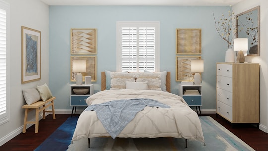 A cozy bedroom featuring elegant blue tones and clean, simple design.