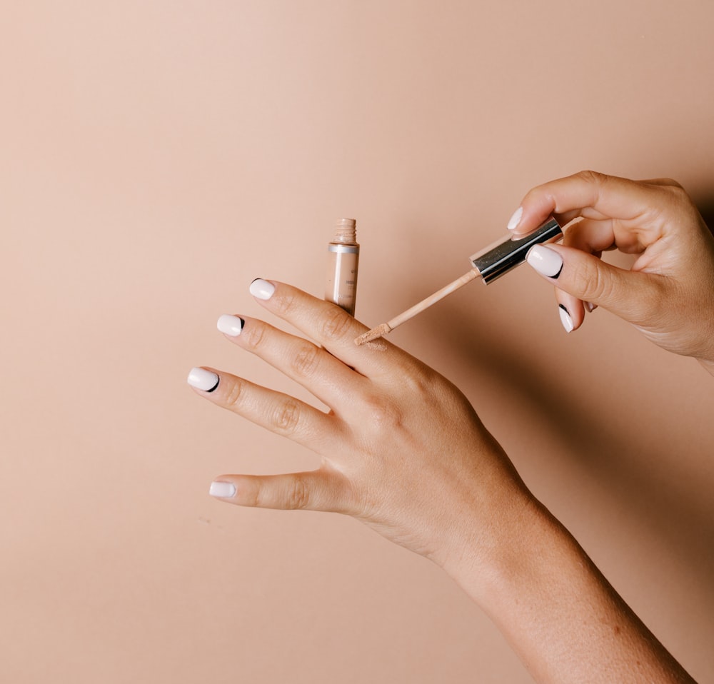 person holding white cigarette stick