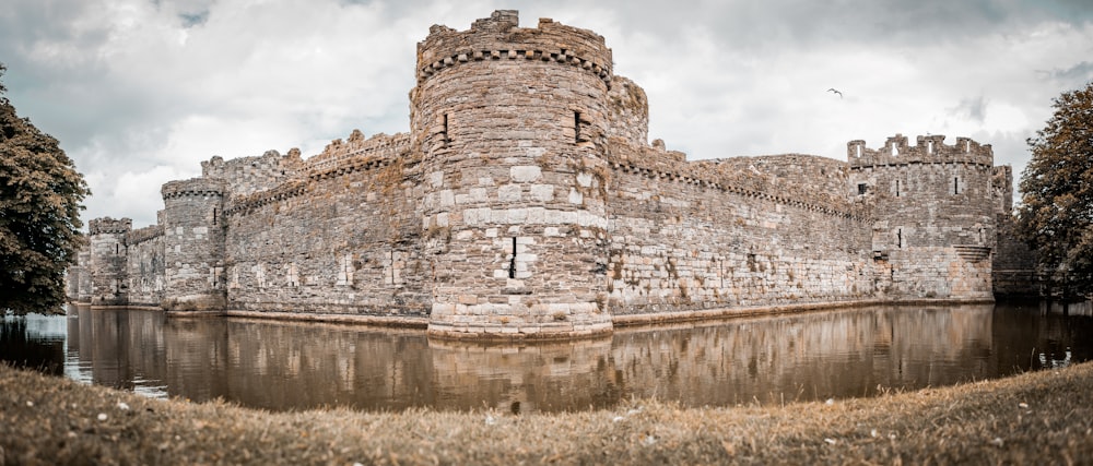 brown brick building near body of water