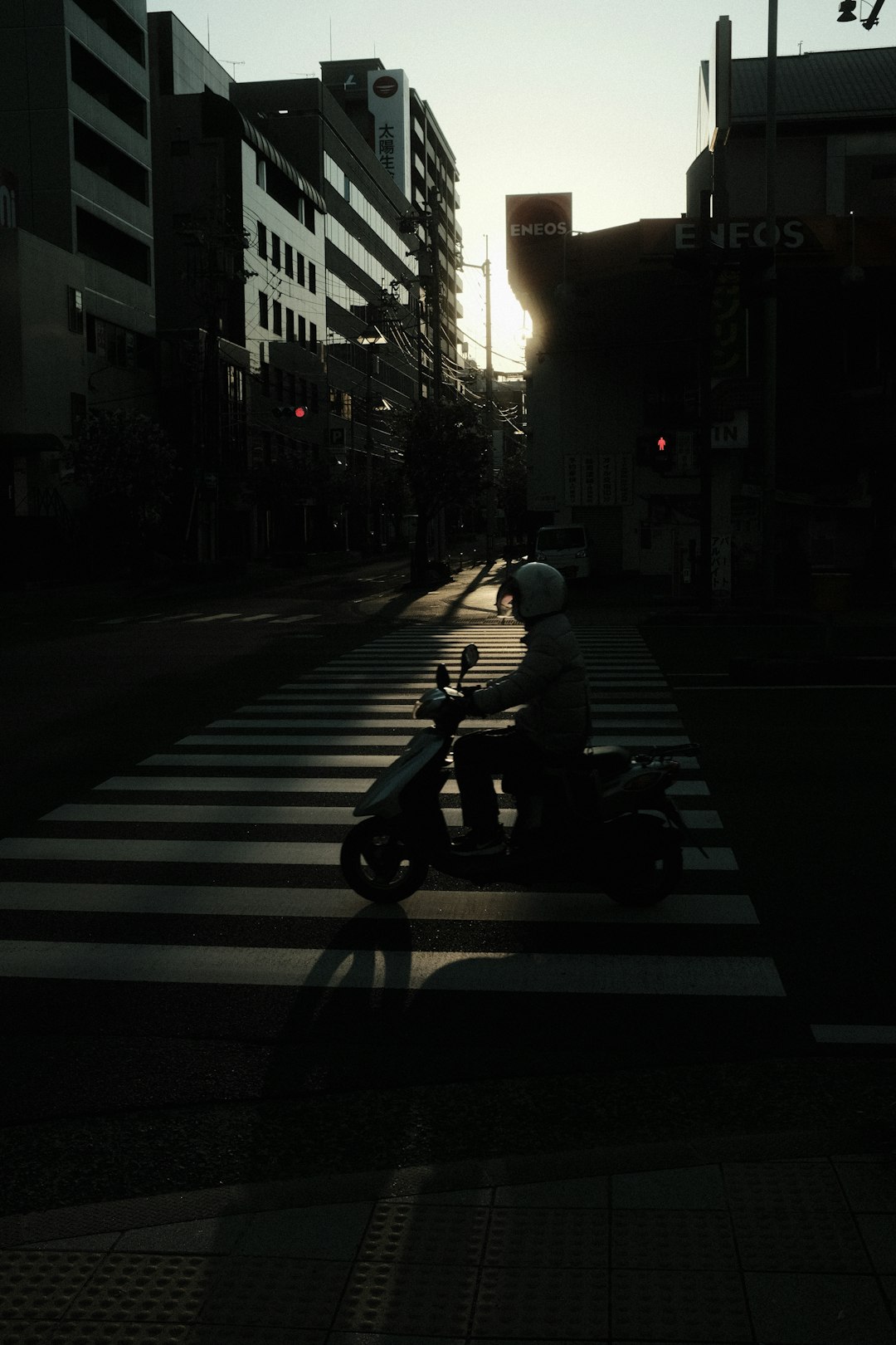 man in black jacket riding motorcycle on road during night time