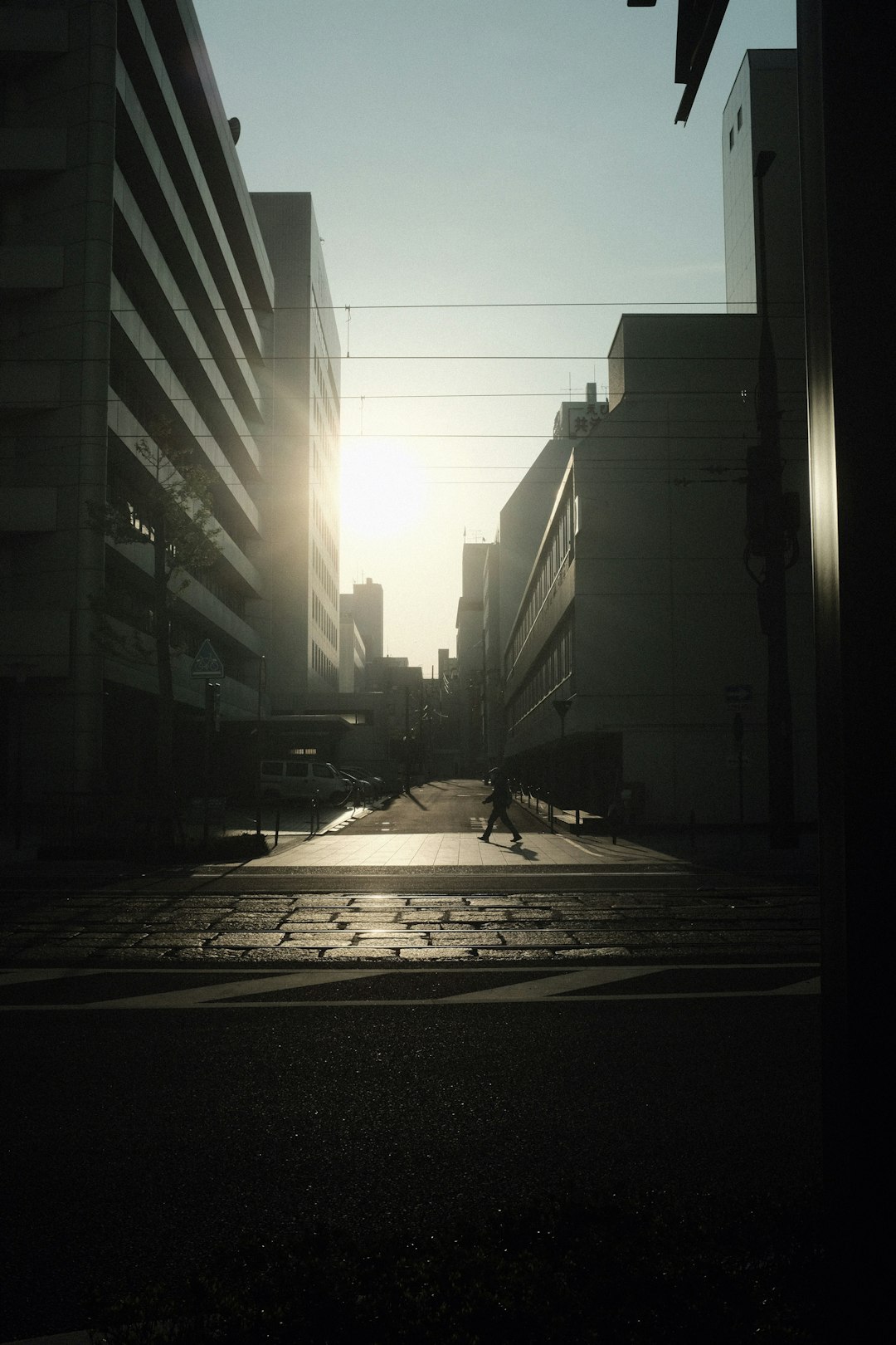 white car on road near high rise buildings during daytime