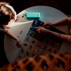 girl in black t-shirt using blue tablet computer