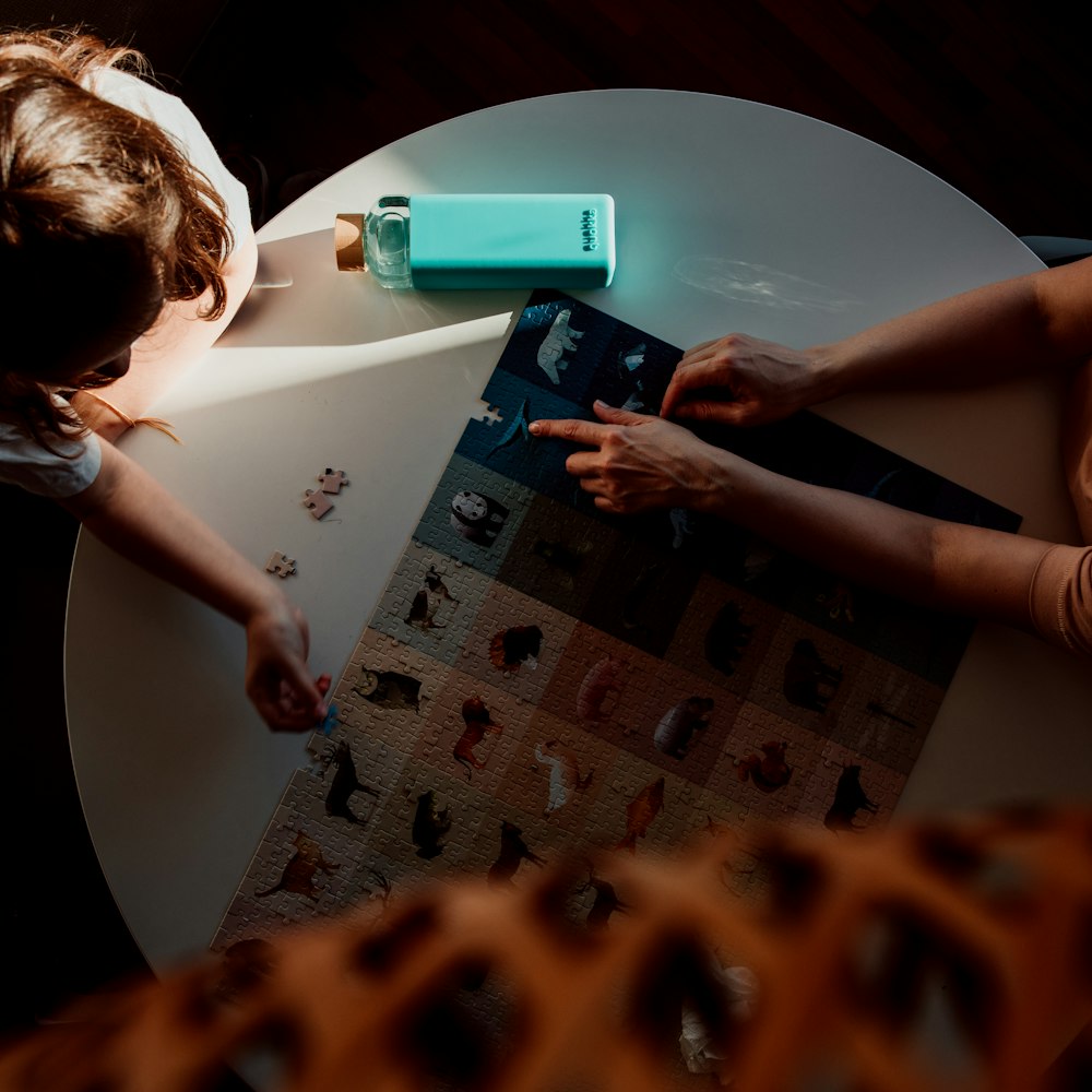 girl in black t-shirt using blue tablet computer