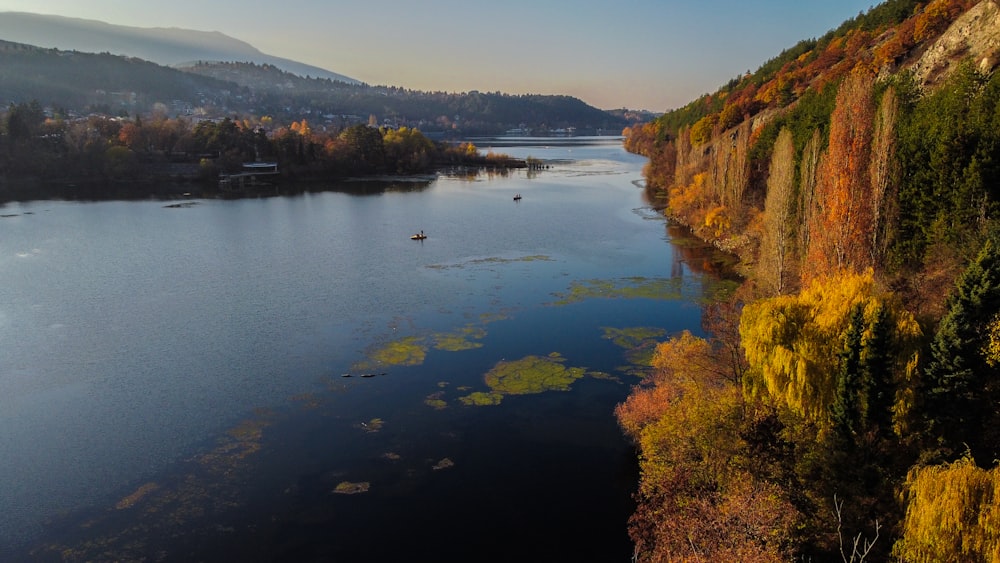 body of water near mountain during daytime