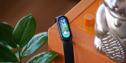 black and silver apple watch with orange strap