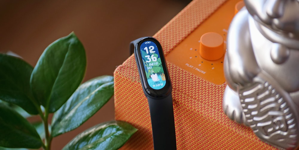 black and silver apple watch with orange strap