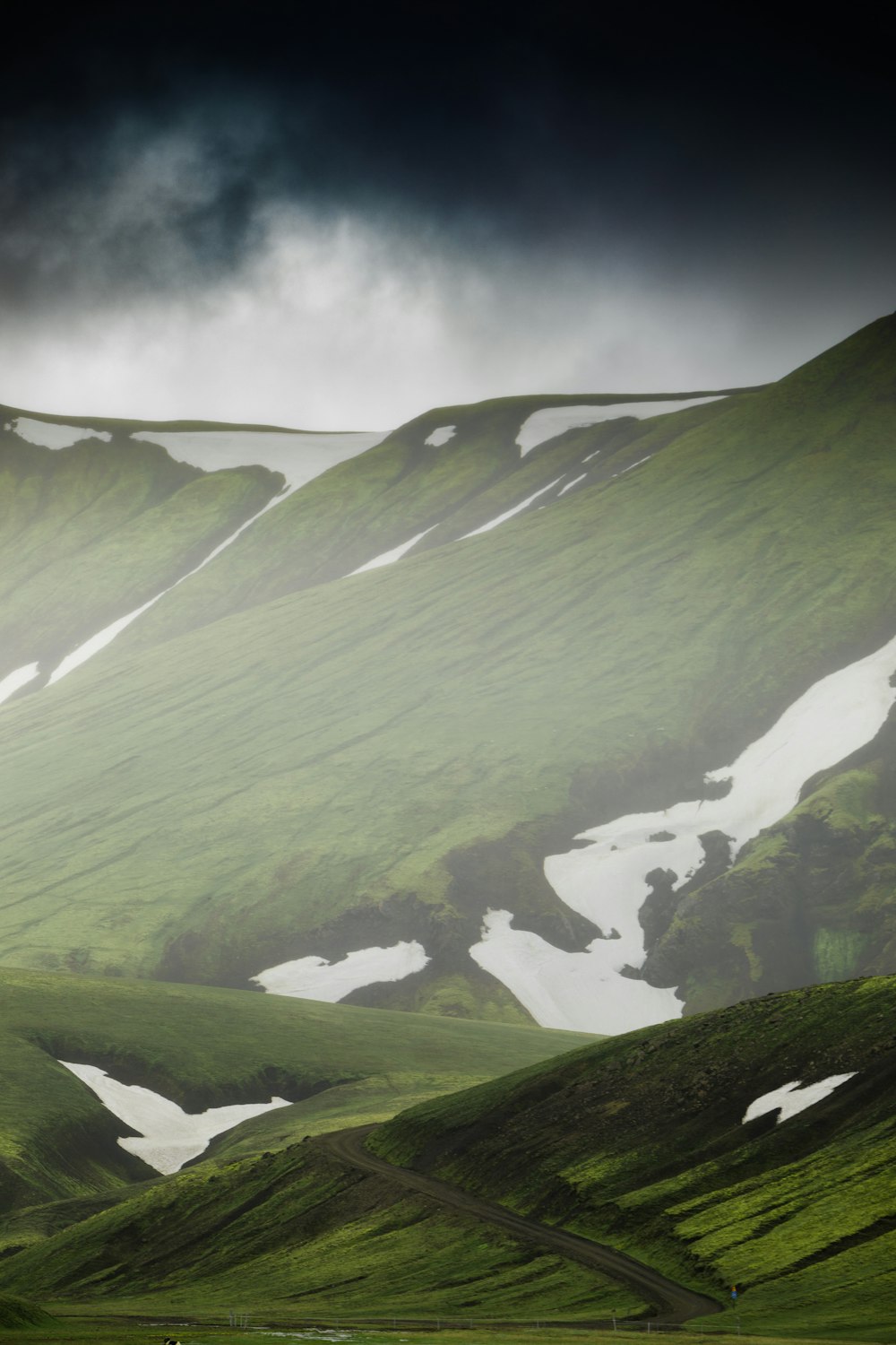 green mountains under white clouds during daytime