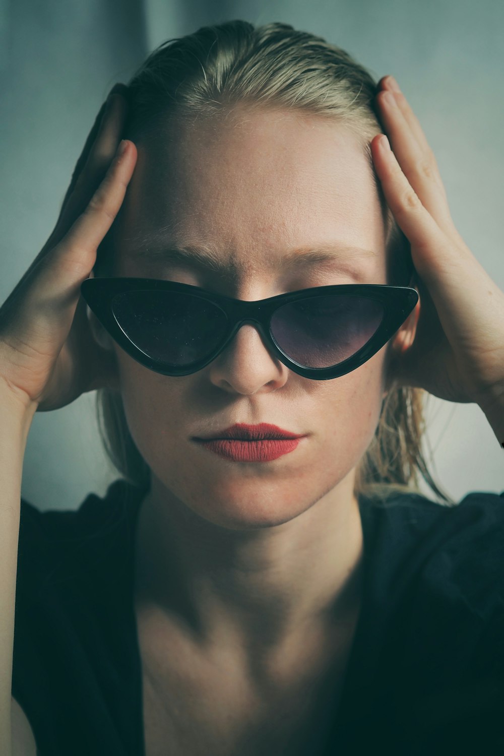 woman in black sunglasses holding her hair