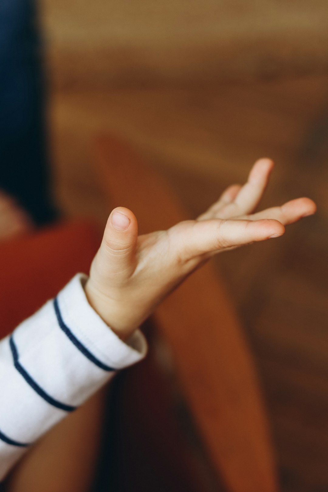 person in white long sleeve shirt showing left hand