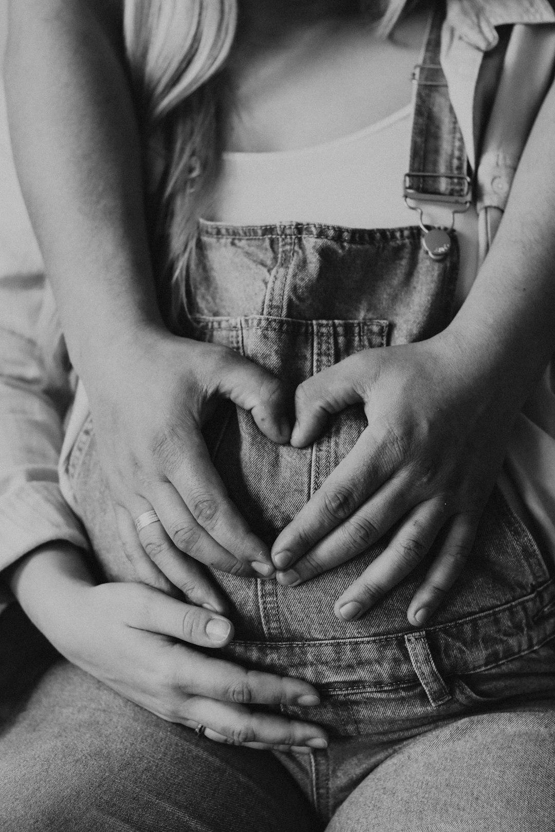 grayscale photo of woman holding her stomach