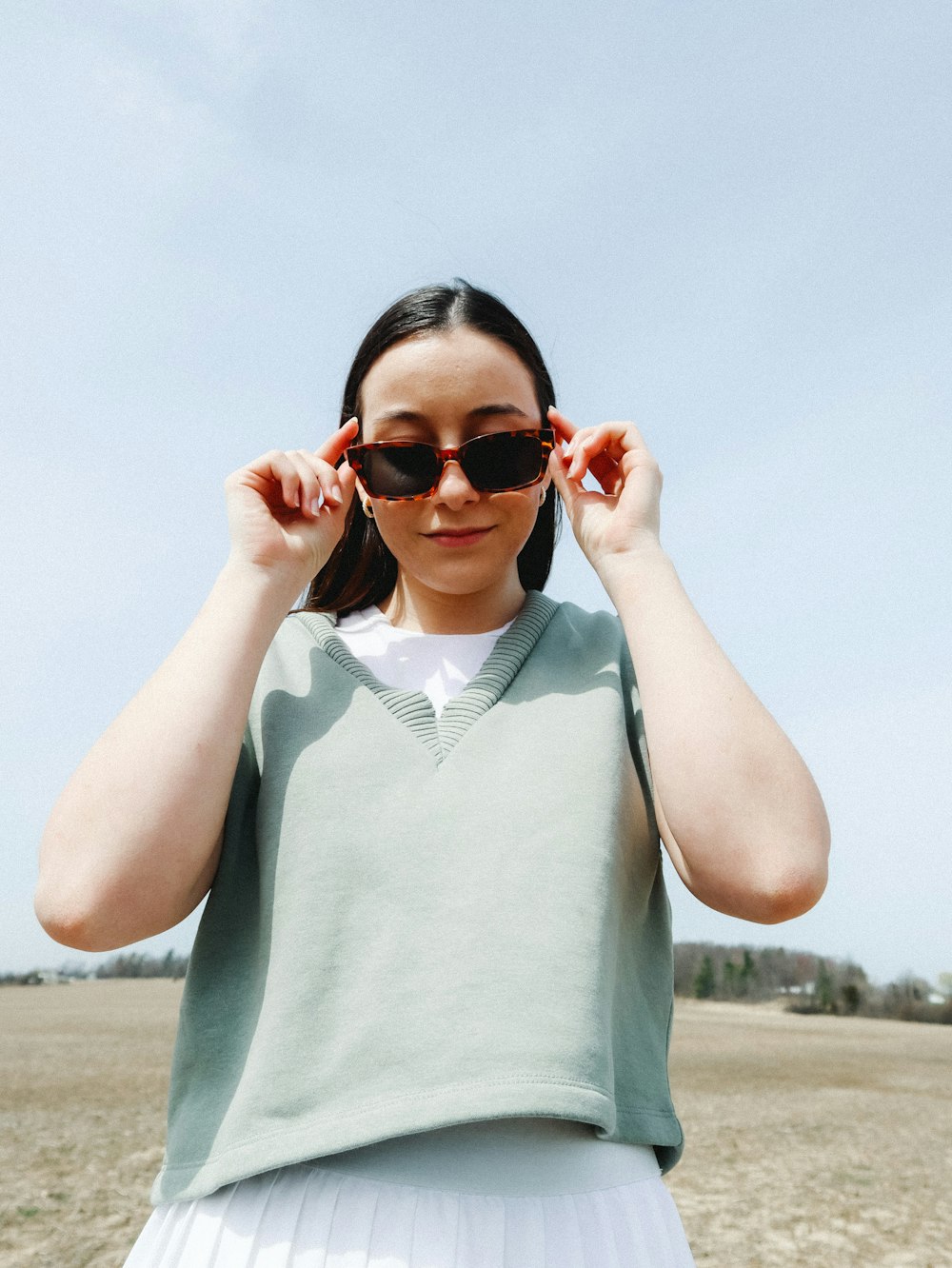 woman in gray tank top wearing brown sunglasses