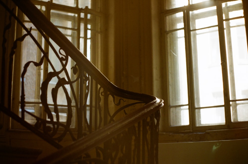 brown wooden staircase near window