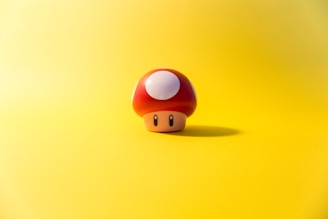 a small mushroom sitting on top of a yellow surface
