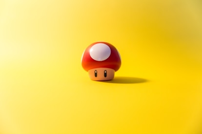 a small mushroom sitting on top of a yellow surface