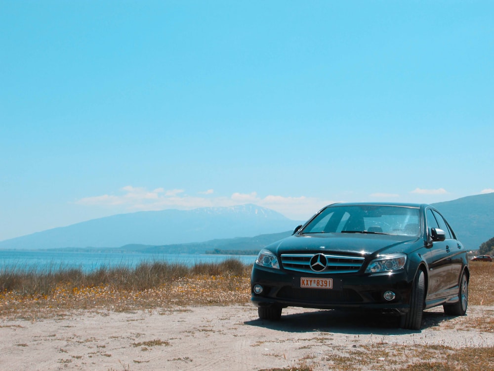 black bmw car on dirt road during daytime