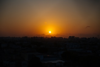 Sunset view of the Chicago skyline seen from the studio rooftop, casting a golden glow.