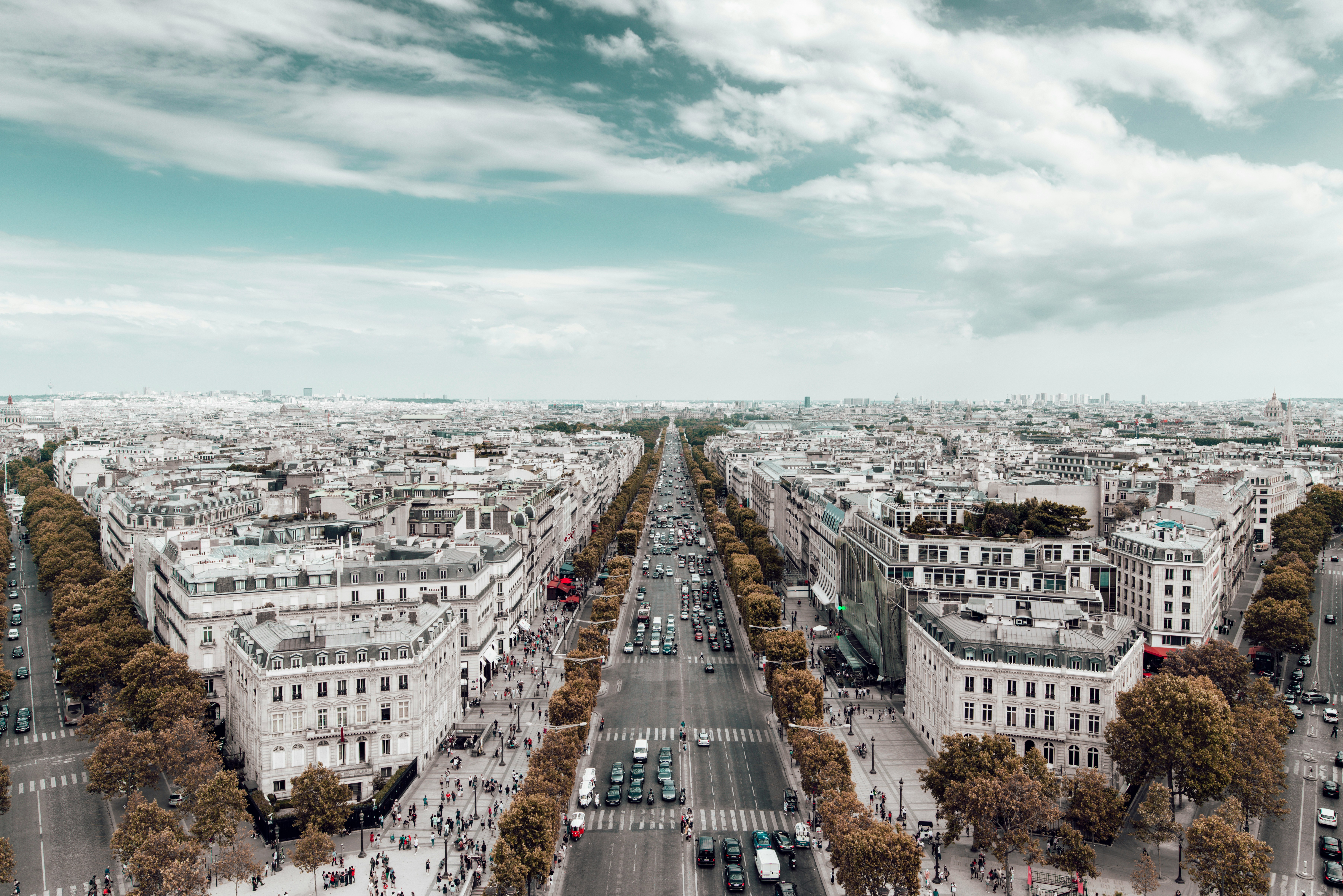 Champs-Élysées in Paris with cloudy sky.
